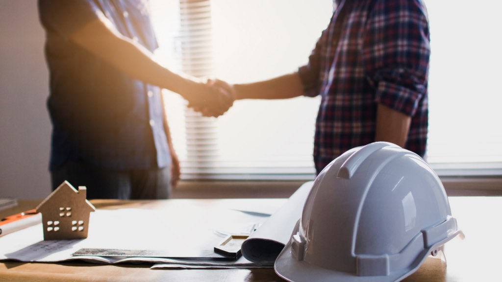 Homebuyer discussing pricing, upgrades, and builder incentives inside a Minnesota model home sales office