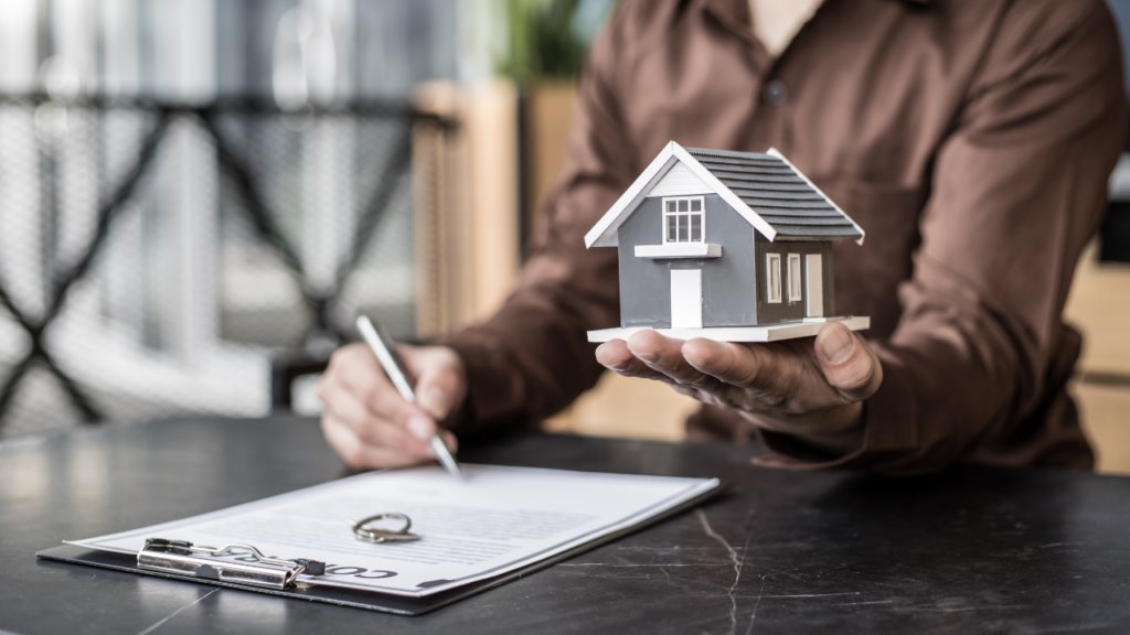 Immigrant gig worker in Minnesota organizing tax returns and bank statements to qualify for a mortgage home loan in the Twin Cities with self-employment income