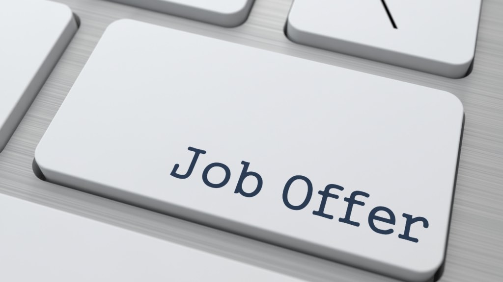 Immigrant professional reviewing job offer and mortgage paperwork in Minnesota