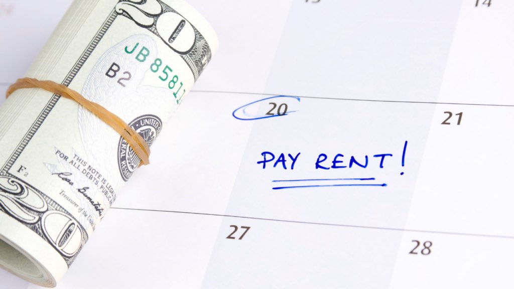 Immigrant renter in Minnesota reviewing rent payment history documentation with a financial advisor to understand how rental payments can help build credit for a home purchase in the Twin Cities