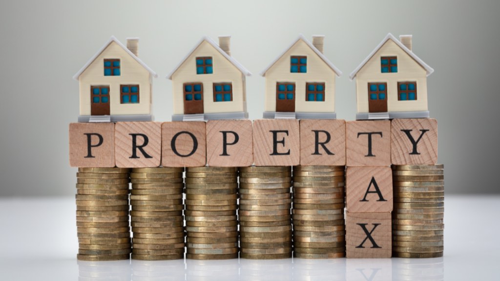 Minnesota homeowner reviewing property tax documents and monthly housing expenses
