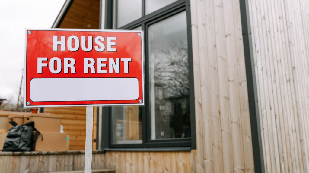 Minnesota homeowner reviewing rental income analysis and property management options before converting their home to a rental property in the Twin Cities