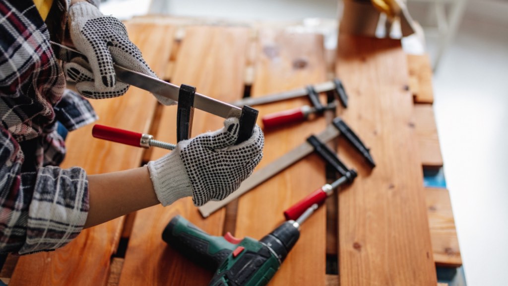 Minnesota homeowner reviewing major repair estimates with a Realtor while deciding whether to fix issues before selling