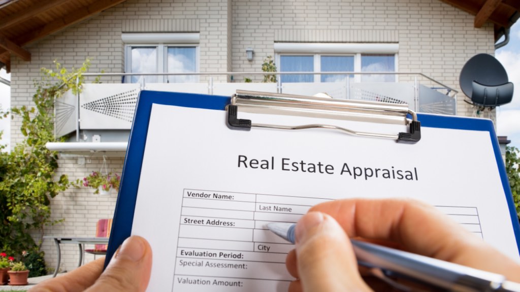 Immigrant homebuyer reviewing a home appraisal report with a Minnesota real estate agent
