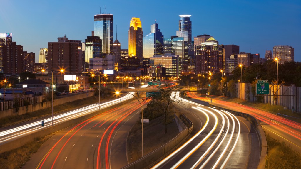 Vibrant busy Minneapolis neighborhood street scene with pedestrians restaurants and commercial activity showing the energy of urban living in an active Twin Cities neighborhood