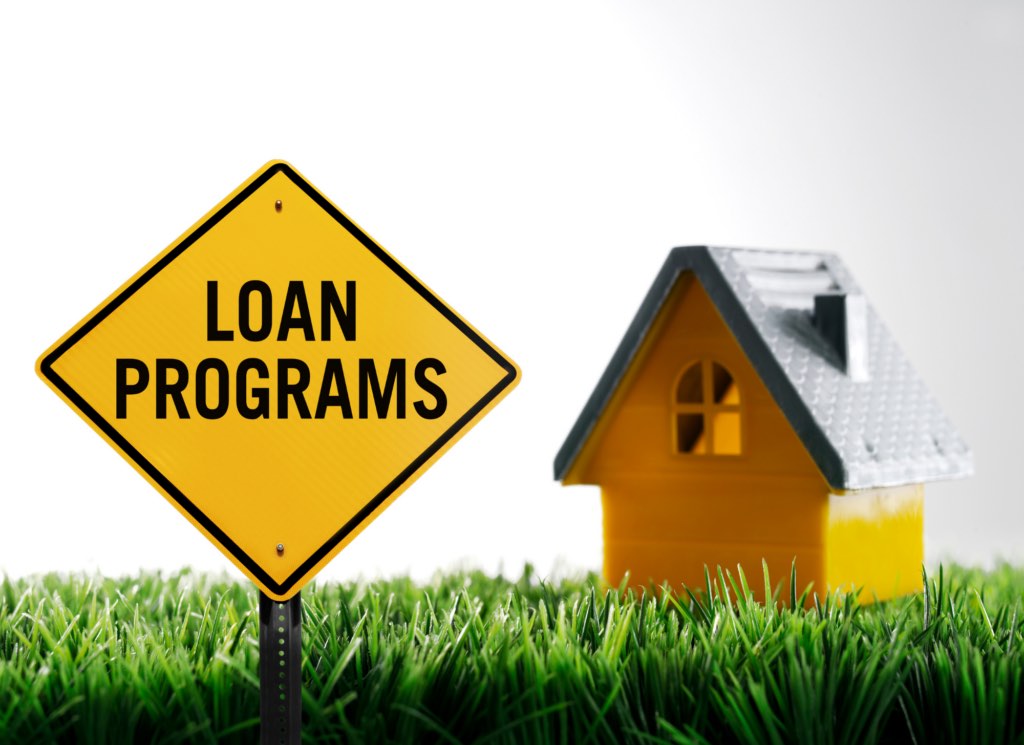 A homeowner reviewing mortgage paperwork representing the Minnesota Housing Step Up loan program for repeat buyers.