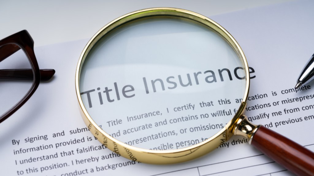 Immigrant homebuyer reviewing title insurance documents with a Minnesota real estate professional before closing