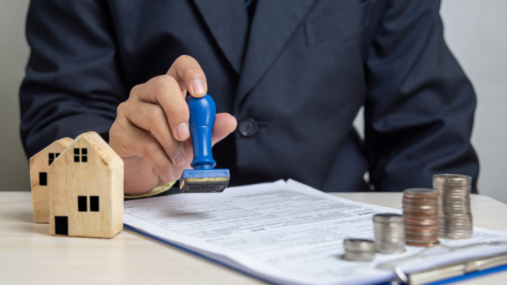 Immigrant homebuyer organizing savings group records and mortgage documents before purchasing a Minnesota home