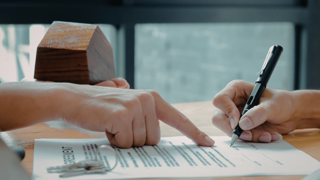Immigrant homebuyer reviewing mortgage documents with lender in Minnesota