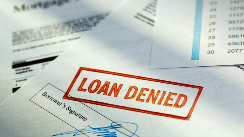 Minnesota homebuyer reviewing mortgage denial risks and financial documents before applying for a home loan