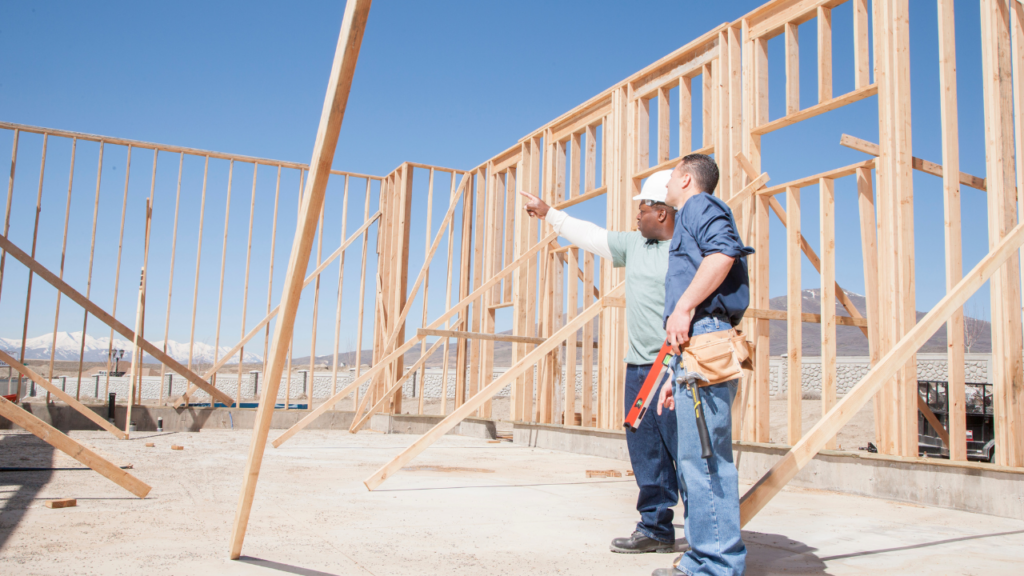 Homebuyer touring a Minnesota builder model home while discussing floor plans and pricing options