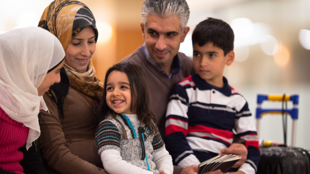 Immigrant homebuyers reviewing multiple-offer strategies with a Minnesota Realtor before submitting a competitive home offer