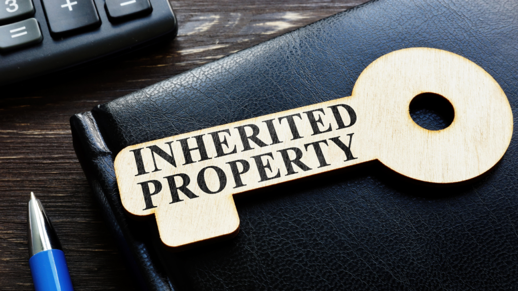 Minnesota Realtor sitting with family members discussing the sale of an inherited home and reviewing estate documents
