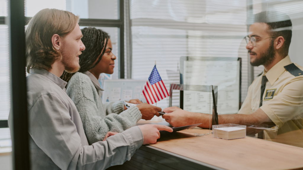 Immigrant family reviewing and signing a competitive home purchase offer with their Minnesota Realtor