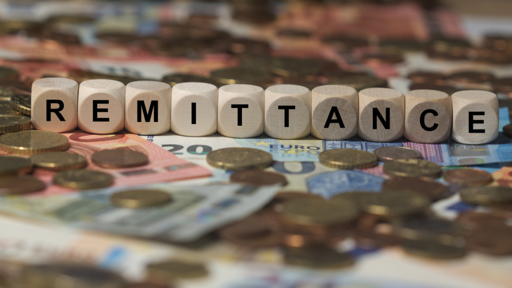 Immigrant homebuyer in Minnesota reviewing income documentation with a mortgage lender to understand how regular remittances to family abroad affect home loan qualification in the Twin Cities