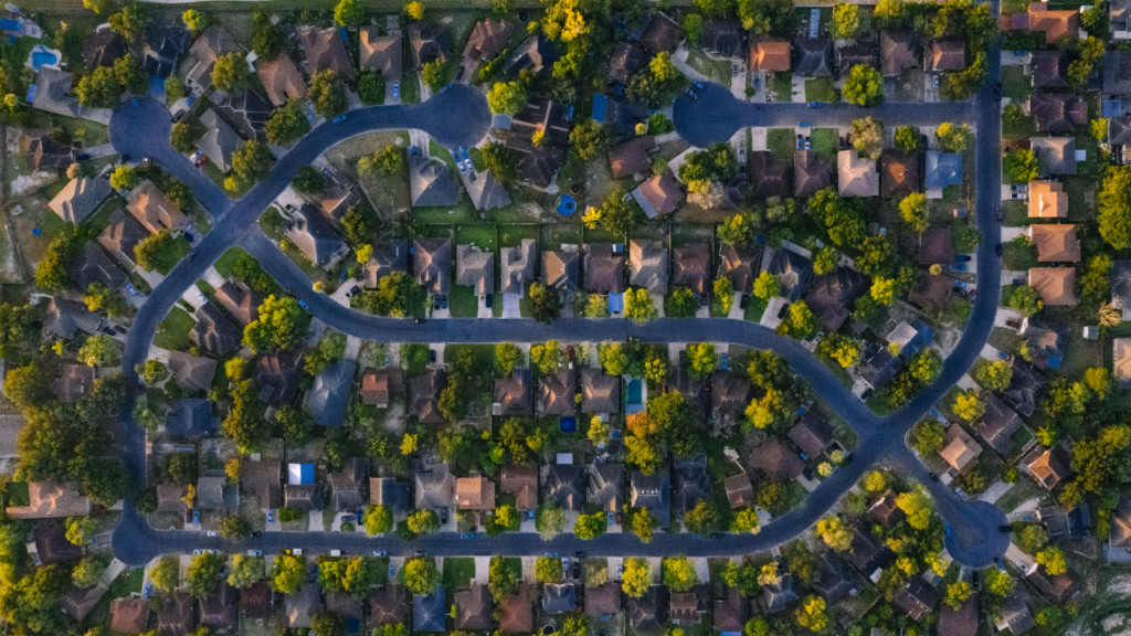 Minnesota homebuyer walking through a neighborhood in the Twin Cities during a community evaluation visit to narrow down location choices