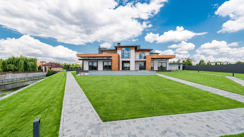 Minnesota home seller reviewing landscaping improvements in front yard with fresh mulch trimmed shrubs and edged lawn before listing their Twin Cities home for sale