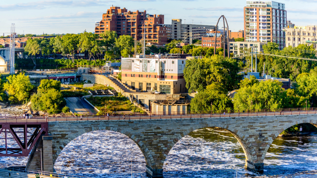 Side by side comparison of downtown Minneapolis urban neighborhood street scene and Twin Cities suburban family neighborhood showing the distinct daily life character of each living environment