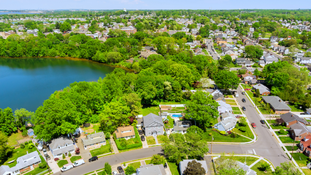 Minneapolis Chain of Lakes shoreline trail alongside Northeast Minneapolis urban neighborhood streetscape showing the two distinct daily life environments available to Minneapolis homebuyers
