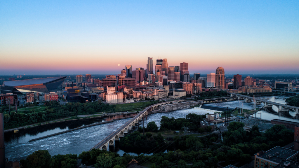 Side by side view of North Loop Minneapolis warehouse district and Uptown Minneapolis neighborhood near Chain of Lakes showing the distinctive character of each urban neighborhood