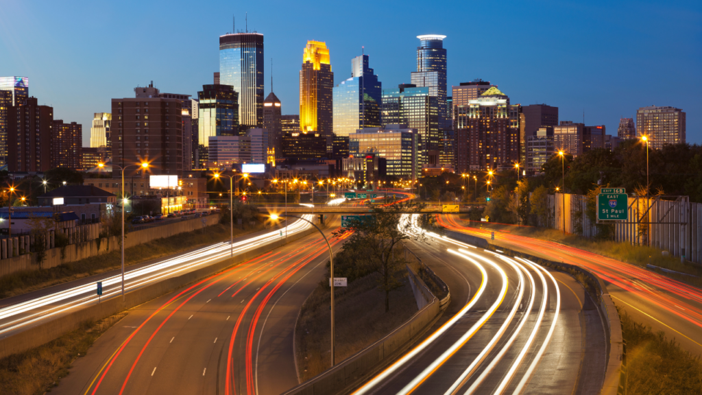 Vibrant busy Minneapolis neighborhood street scene with pedestrians restaurants and commercial activity showing the energy of urban living in an active Twin Cities neighborhood