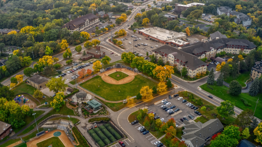 Minnesota first-time homebuyer couple walking through a suburban neighborhood near Minneapolis evaluating communities for their first home purchase in the Twin Cities