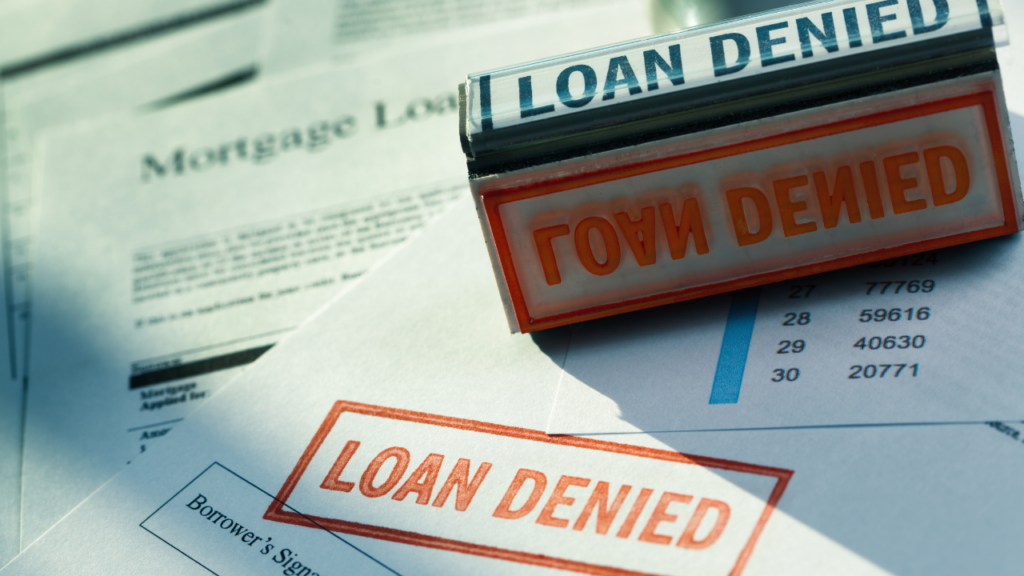 Minnesota homebuyer reviewing mortgage denial letter with a Realtor to understand the reasons and next steps in the Twin Cities