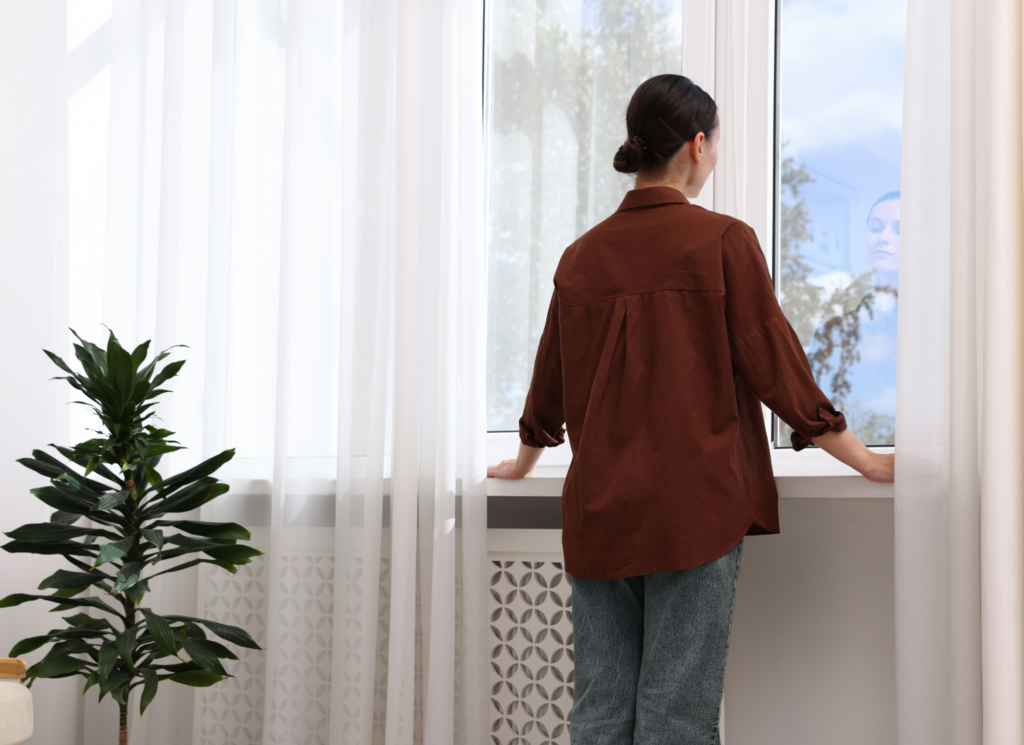 A worried homebuyer reviewing a purchase agreement at a kitchen table, considering whether to back out of a home purchase.