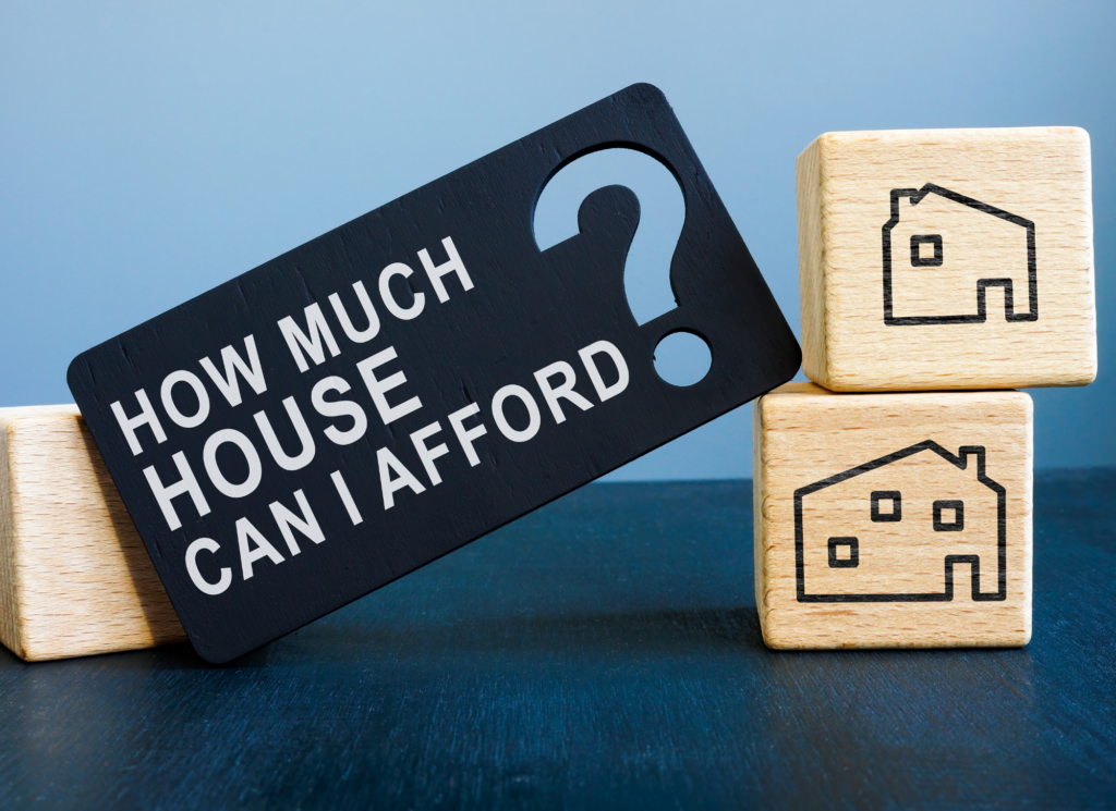 A Minnesota homebuyer reviewing a household budget and calculator while planning how much home they can comfortably afford.